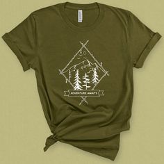 Adventure awaits t-shirt for women is the perfect camping tee with a rustic nostalgic feel. Wear this mountains graphic tee while enjoying nature and the great outdoors graphic. Grab your gear and head out in your new backpacking shirt this summer! DETAILS This Beautiful graphic t-shirt is made of 49% to 100% combed and ring-spun cotton and is very soft and comfortable to wear. Check the size card for specific fabrications per color. We use DTG technology and eco friendly inks allowing us to pro Mountains Graphic, Mountain Graphic Tee, Summer Details, Enjoying Nature, Cut Tees, T Shirt For Women, Better Love, Adventure Awaits