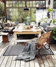 an image of a living room with furniture and plants on the floor in front of it