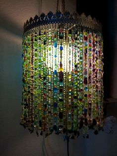 a chandelier made out of glass beads hanging from the ceiling in a room