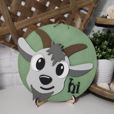 a wooden sign with an animal's head and the word b i on it