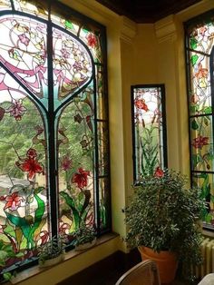 two large stained glass windows with plants in the center and one on the other side