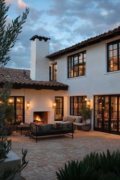 a house with a fire place in the middle of it's courtyard and patio