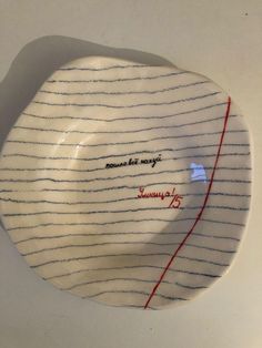 a white plate with red writing on it