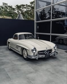 an old mercedes car parked in front of a building