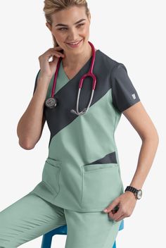 Do you crave fashion in your scrub top collection? Each top showcases two contrasting colors in an asymmetric pattern for a modern look. Each piece in our Butter-soft Stretch scrub collection was designed for 12+ hour shifts, and made from easy-care, 2-way stretch comfort fabric. • Classic fit • V-neck • Total of 5 pockets • 2 double pockets • 1 cell phone pocket • Short sleeve • Side vents • Back darts • Approximate length for size M is 27 1 2” The key to comfort? Cotton and 2-way stretch. They Stylish Scrubs For Women, Male Scrubs, Nursing Scrubs Pattern, Scrubs Pattern