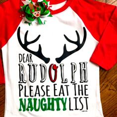 Dear Rudolph Please Eat The Naughty List Saying Across Front Of Top. A White Next Level Raglan Style With Red Sleeves. A Heat Transfer Of Rudolph Antlers With Cute Saying. Outfit Complete For The Girls A With Coordinating Bow That Is Included In Purchase. Shirt Could Be Unisex Too For Little Boys Without The Bow Of Course. Same Day Shipping If Purchases By 3pm Central. Smoke Free Home Boutique Funny Kids Christmas Shirts, Funny Christmas Shirts For Kids, Christmas Pj Ideas, Rudolph Shirt, Christmas Graphic Tees, Pj Ideas, Toddler Christmas Shirt, Tshirts Ideas, Reindeer Shirt