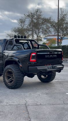 a black truck parked in a parking lot