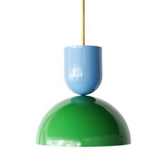 a green and blue light fixture with a wooden stick sticking out of it's top