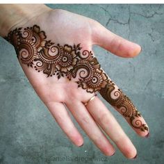 the hand is decorated with henna designs