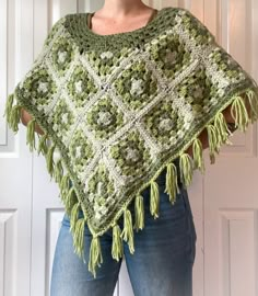 a woman wearing a green and white crocheted shawl