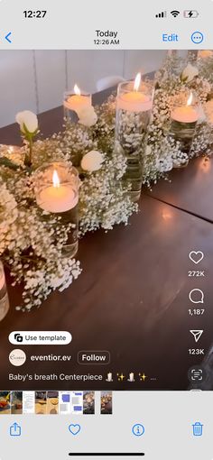 candles are arranged on a table with flowers and baby's breath centerpieces