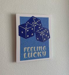 a blue and white card with two dices on it that says feeling lucky in the middle