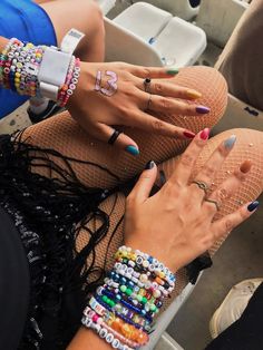 two women with colorful nails and bracelets on their feet