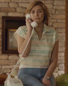 a woman sitting on a table talking on the phone