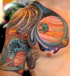 a man with tattoos on his chest has planets in the sky and stars around him