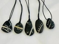 four black and white stone pendants with silver beads