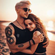 a man and woman hugging on the beach