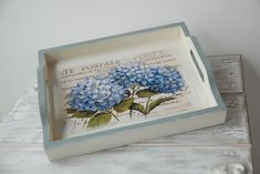 a small tray with blue flowers on it