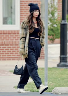 a woman walking down the street with a handbag