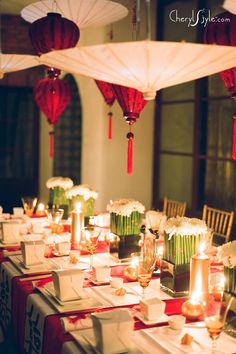 a long table is set with candles and napkins for an elegant chinese wedding reception