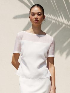 This is a feminine and modern blouse by RE RHEE that is made out of high quality and sturdy material. With distinctive mood of the design and comfortable wear, you can style it for your casual daily outfit.- High quaity triacetate blend fabric- Tuck detail on the back- Zipper closure on the back- Minimal and feminine mood Elegant White Viscose Top, Chic Fitted Mesh Top For Workwear, Chic Summer Office Tops, Chic Fitted Blouse With Crew Neck, Versatile Summer Office Blouse, Fitted Crew Neck Elegant Blouse, White Silk Summer Tops, Chic Viscose Tops For Workwear, Modern Short Sleeve Blouse For Office