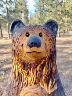 a carved bear sitting on top of a tree stump