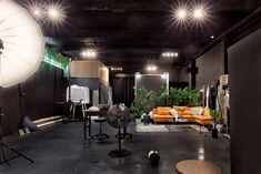 a room with lights, couches and other items on the floor in front of them