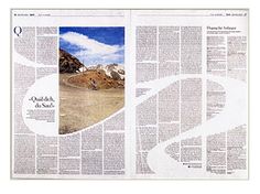 a newspaper with an image of mountains in the middle and a road running through it