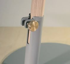 a close up of a metal object with a wooden stick sticking out of it's center