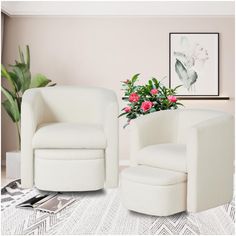 two white chairs in a living room with pink flowers on the table and potted plant