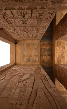 an empty room with egyptian paintings on the walls and ceiling, in front of a window