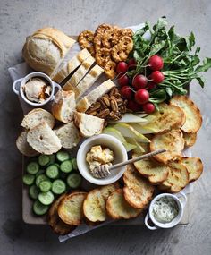 a platter filled with bread, crackers and vegetables