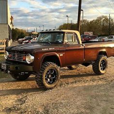 an old pickup truck is parked in the dirt