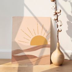 a vase sitting next to a painting on top of a wooden floor in front of a white wall