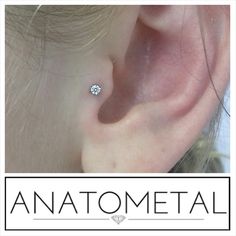 an ear is shown with the words anatometal written in white lettering on it