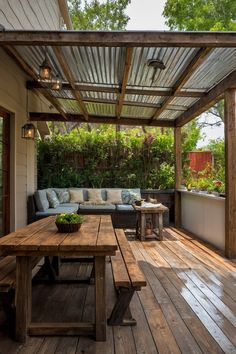 an outdoor patio with wood flooring and wooden table on the outside deck, surrounded by greenery