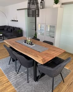 a wooden table with chairs around it in a living room