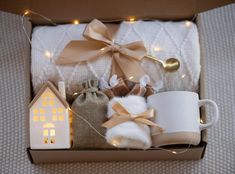 an open box with some items in it and lights on the side, including a mug