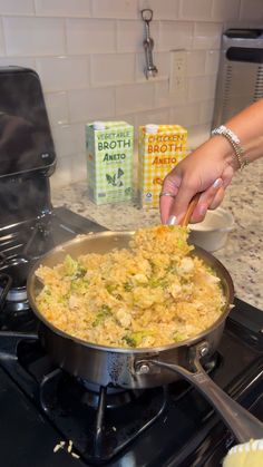 a person is cooking food in a pan on the stove