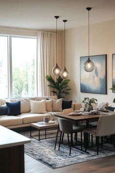 a living room filled with furniture and a dining table in front of a large window