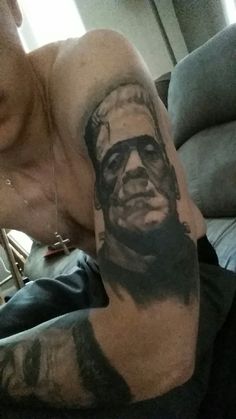 a man with a tattoo on his arm has a portrait of abraham lincoln painted on it