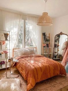 a bed room with a neatly made bed next to a window and a mirror on the wall