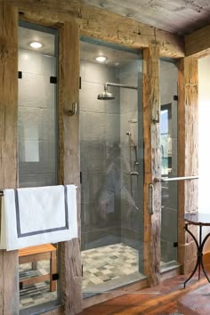 a bathroom with a walk in shower next to a table