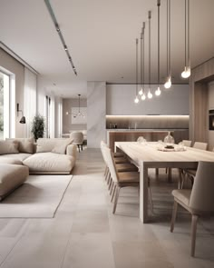 a living room and dining area with couches, chairs, tables and lamps hanging from the ceiling