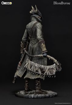 a figurine is shown on a black background with the caption bloodborne