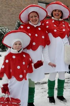 three people dressed in costumes standing in the snow