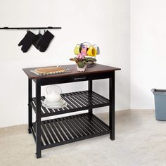 a kitchen island with pots and pans on it in front of a white wall