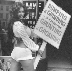 a woman holding a sign that says bumping and grinding is better than gruniting and growing