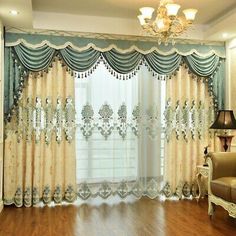 a living room with wooden floors and curtains on the windowsills, along with a couch