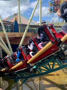 people riding on a roller coaster at a theme park